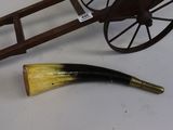 a horn and a wooden cart on a table