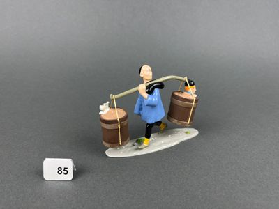 a figurine of a man on a surfboard with two barrels