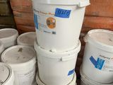 several buckets of paint are stacked on top of each other