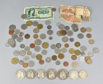 a pile of coins and money on the table