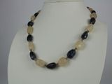 necklace with black and white beads on a white mannequin