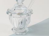 a clear glass jar with a spoon and a spoon in it