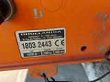 a close up of an orange machine with a number plate on it