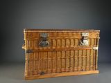 a wicker trunk with a metal latch on it