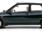 a small black car that is parked on a white surface