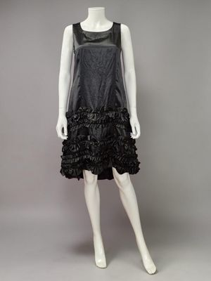 a black leather dress with ruffles on a mannequin mannequin mannequin mannequin mannequin mannequin mannequin mann
