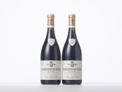 two bottles of wine sitting next to each other on a table