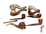 several different types of pipe smokings are lined up on a white surface