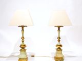 pair of brass table lamps with shades on each of them