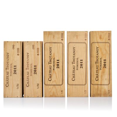 four wooden boxes of wine are lined up on a white surface