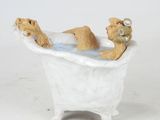 figurine of a teddy bear in a bathtub with a teddy bear