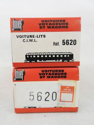 two boxes of toy trains are stacked on top of each other