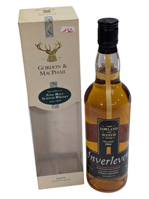 a bottle of scotch and a box on a white background
