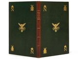 un livre vert et doré avec un oiseau sur la couverture