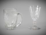 two empty glasses sitting next to each other on a table