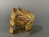 an image of a close up of a gold ring on a table