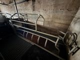 a metal bed in a dirty room with a door open