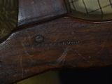 a clock on the back of a wooden chair