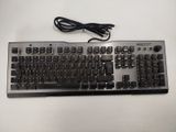 a computer keyboard with a cord attached to it