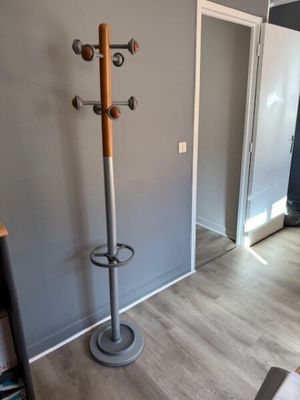 an image of a coat rack in the corner of a room