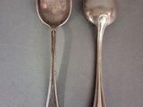 two spoons sitting next to each other on a table