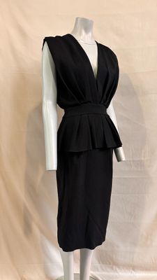 a picture of a black dress on a mannequin stand