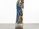 a statue of a woman holding a child on a cart