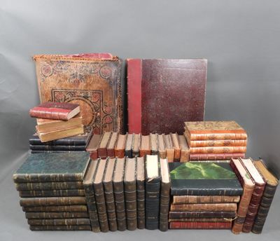 several old books stacked on top of each other on a table