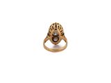 a close up of a gold ring with a pearl in it