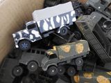 a box full of toy army vehicles and other toys