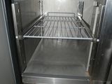 an empty stainless steel refrigerator with a door open