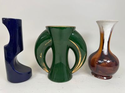 three vases sitting next to each other on a white surface
