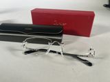 glasses are laying on a table next to a red box and a pair of glasses