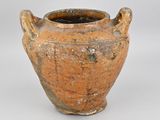 a brown vase that is sitting on a white surface