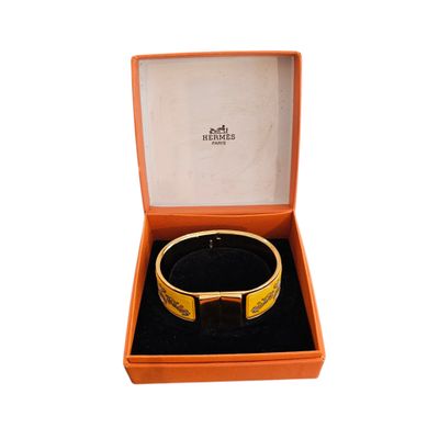 an orange box with a bracelet inside of it on a white surface