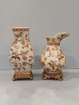 two vases that are sitting next to each other on a table