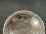 a silver spoon with a silver handle on a table