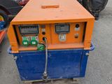 an orange and blue machine sitting on top of a parking lot