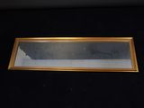 a picture of a gold framed mirror on a black surface