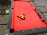 a pool table with a pool ball and cues on it