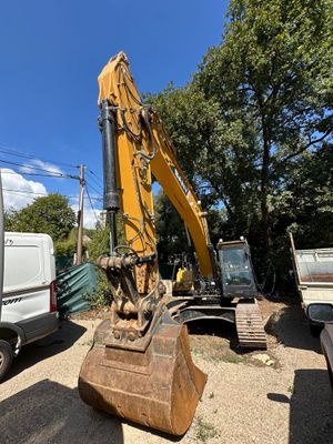 a yellow excavator that is sitting in the dirt