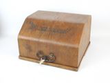 a small wooden box with a key on it