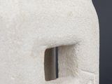 a close up of a sculpture of a face with a hole in it