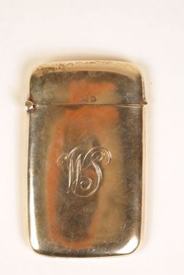 an antique silver cigarette case with a monogram on the front