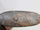 someone is holding a knife in their right hand with a rusted handle