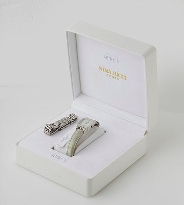 a white box with a pair of scissors inside of it