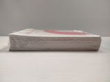 a stack of newspapers sitting on a white table