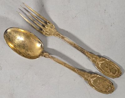 two spoons and a fork sitting on a table