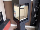 a glass display case with a fish in it in the corner of a room