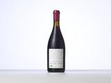 a bottle of red wine sitting on top of a table